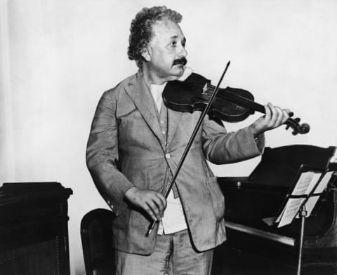 Albert Einstein plays a violin.