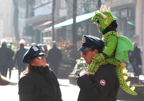 A child dressed as a dragon celebrates Ash Wednesday with his parents (dressed as police officers) in 2011.