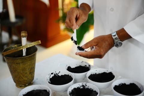 A priest prepares black ashes for the Ash Wednesday ceremony in Surabaya, Indonesia in 2014.