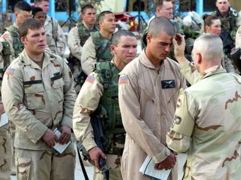 A minister performs an Ash Wednesday service at the Kandahar Airbase in Kandahar, Afghanistan in 2002.