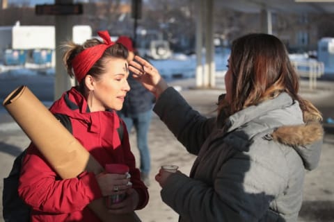 In celebration of Ash Wednesday, a member of the Urban Village Church rubs ashes on the forehead of a commuter outside of a subway station in Chicago in 2018.