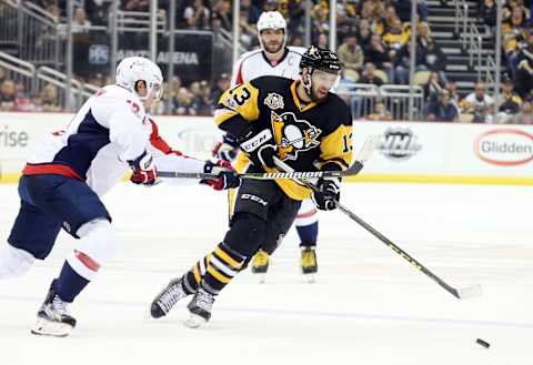 Jan 16, 2017; Pittsburgh, PA, USA; Washington Capitals center Nicklas Backstrom (left) defends Pittsburgh Penguins center Nick Bonino (13) during the third period against at the PPG PAINTS Arena. The Penguins won 8-7 in overtime. Mandatory Credit: Charles LeClaire-USA TODAY Sports