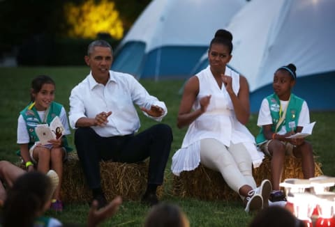 Barack and Michelle Obama camping with Girl Scouts.