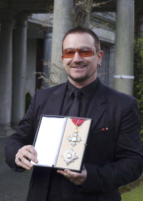 Bono poses after receiving a knighthood in recognition of his services to the music industry and his humanitarian work in 2007.