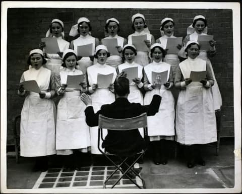 A nurses' choir practices outside a London hospital.