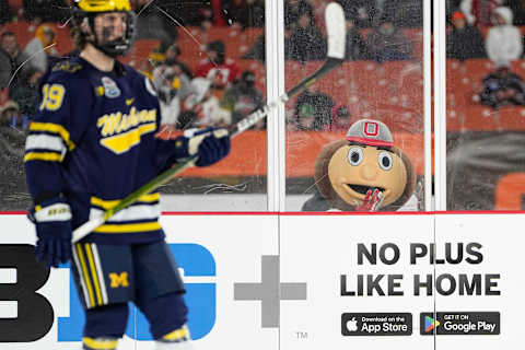 Feb 18, 2023; Cleveland, Ohio, USA; Brutus Buckeye watches Michigan Wolverines forward Adam Fantilli (19) during third period of the Faceoff on the Lake outdoor NCAA men’s hockey game at FirstEnergy Stadium. Ohio State won 4-2. Mandatory Credit: Adam Cairns-The Columbus DispatchHockey Ncaa Men S Hockey Michigan Wolverines At Ohio State Buckeyes