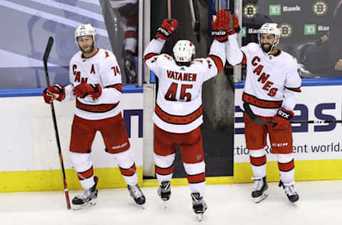 Jaccob Slavin #74, Sami Vatanen #45, and Vincent Trocheck #16 of the Carolina Hurricanes celebrate. (Photo by Elsa/Getty Images)