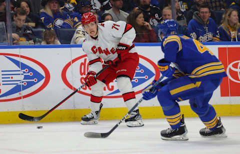 Apr 8, 2023; Buffalo, New York, USA; Carolina Hurricanes right wing Jesper Fast (71) looks to make a pass as Buffalo Sabres defenseman Ilya Lyubushkin (46) defends during the first period at KeyBank Center. Mandatory Credit: Timothy T. Ludwig-USA TODAY Sports