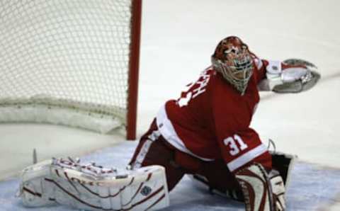 DETROIT – MAY 1: Goalie Curtis Joseph #31 of the Detroit Red Wings protects the net from the Calgary Flames in game 5 of the Western Conference Semifinals during the 2004 NHL Playoffs at the Joe Louis Arena on May 1, 2004 in Detroit, Michigan. The Flames won 1-0. (Photo by Tom Pidgeon/Getty Images)