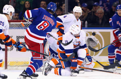 NEW YORK, NEW YORK – MARCH 17: Jacob Trouba #8 of the New York Rangers shoots the puck past Zach Parise #11 of the New York Islanders during the first period at Madison Square Garden on March 17, 2022, in New York City. (Photo by Bruce Bennett/Getty Images)