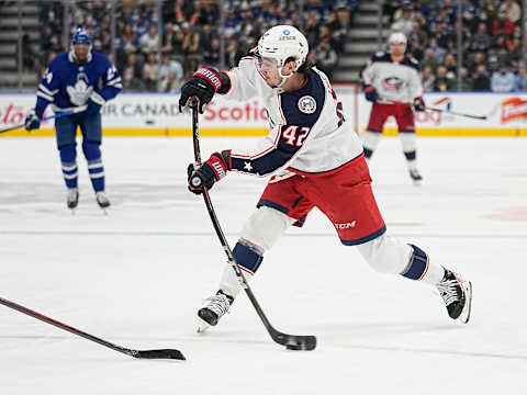 Dec 7, 2021; Toronto, Ontario, CAN; Columbus Blue Jackets forward Alexandre Texier (42) shoots the puck against the Toronto Maple Leafs during the second period at Scotiabank Arena. Mandatory Credit: John E. Sokolowski-USA TODAY Sports