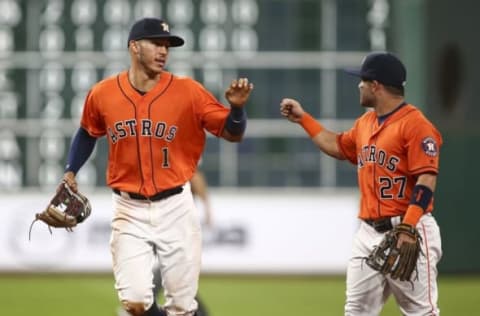 Sep 23, 2016; Houston, TX, USA; Houston Astros shortstop Carlos Correa (1) celebrates with second baseman Jose Altuve (27) after making a defensive play during the fifth inning against the Los Angeles Angels at Minute Maid Park. Mandatory Credit: Troy Taormina-USA TODAY Sports