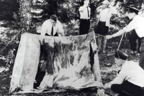 Finnish investigators examine the Lake Bodom crime scene in Espoo, Finland in June 1960.