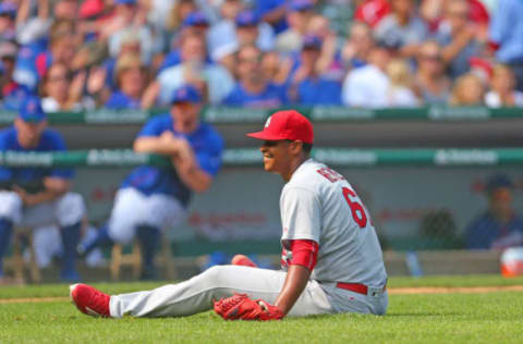 Sep 24, 2016; Chicago, IL, USA; St. Louis Cardinals starting pitcher Alex Reyes (61) reacts to falling down trying to field an infield single off the bat of Chicago Cubs shortstop Addison Russell (not pictured) during the third inning at Wrigley Field. Mandatory Credit: Dennis Wierzbicki-USA TODAY Sports