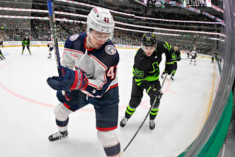 Oct 30, 2023; Dallas, Texas, USA; Columbus Blue Jackets center Alexandre Texier (42) and Dallas Stars center Wyatt Johnston (53) battle for the puck during the second period at the American Airlines Center. Mandatory Credit: Jerome Miron-USA TODAY Sports