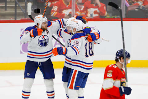 Nov 12, 2022; Sunrise, Florida, USA; Edmonton Oilers left wing Warren Foegele (37) celebrates with center Leon Draisaitl (29) and left wing Zach Hyman (18) after scoring during the third period against the Florida Panthers at FLA Live Arena. Mandatory Credit: Sam Navarro-USA TODAY Sports