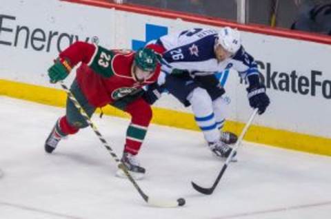 Sep 27, 2014; Saint Paul, MN, USA; Minnesota Wild defenseman Gustav Olofsson (23) and Winnipeg Jets right wing Blake Wheeler (26) skate after the puck in the third period at Xcel Energy Center. The Minnesota Wild win 4-3. Mandatory Credit: Brad Rempel-USA TODAY Sports