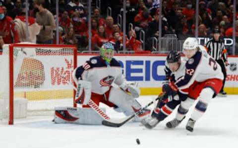 Dec 4, 2021; Washington, District of Columbia, USA; Washington Capitals defenseman Dmitry Orlov (9) and Columbus Blue Jackets defenseman Jake Bean (22) battle for the puck in front of Blue Jackets goaltender Daniil Tarasov (40) during the first period at Capital One Arena. Mandatory Credit: Geoff Burke-USA TODAY Sports