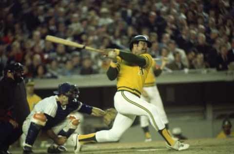 FLUSHING, NY – OCTOBER 1973: Reggie Jackson #9 of the Oakland Athletics swats the ball during the World Series against the New York Mets at Shea Stadium on October 1973 in Flushing, New York. (Photo by Focus On Sport/Getty Images)