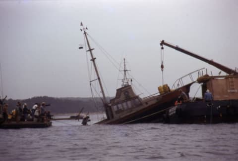 The Orca II sinks on command as the crew looks on during the filming of Jaws.