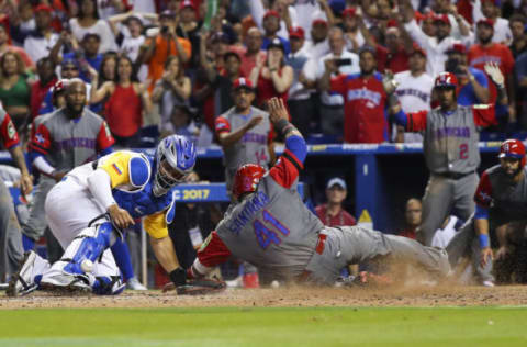 Mar 12, 2017; Miami, FL, USA; Dominican Republic infielder Carlos Santana (41) slides safe at home as Colombia catcher Jorge Alfaro (38) fields a ball in the eleventh inning during the 2017 World Baseball Classic at Marlins Park. Dominican Republic 10-3. Mandatory Credit: Logan Bowles-USA TODAY Sports