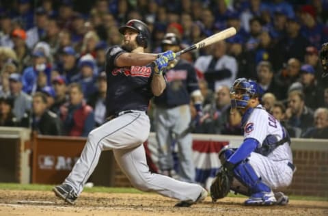 Oct 30, 2016; Chicago, IL, USA; Cleveland Indians first baseman Mike Napoli (left) hits a single in front of Chicago Cubs catcher Willson Contreras (right) during the seventh inning in game five of the 2016 World Series at Wrigley Field. MLB. Mandatory Credit: Jerry Lai-USA TODAY Sports