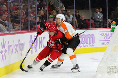 RALEIGH, NC – NOVEMBER 21: Carolina Hurricanes left wing Brock McGinn (23) with the puck while Philadelphia Flyers defenseman Robert Hagg (8) gets ready to push him into the glass during the 3rd half of the Carolina Hurricanes game versus the New York Rangers on November 21st, 2019 at PNC Arena in Raleigh, NC (Photo by Jaylynn Nash/Icon Sportswire via Getty Images)