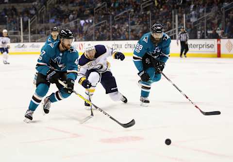 SAN JOSE, CA – OCTOBER 12: Joakim Ryan #47 and Brent Burns #88 of the San Jose Sharks go for the puck against Zemgus Girgensons #28 of the Buffalo Sabres at SAP Center on October 12, 2017 in San Jose, California. (Photo by Ezra Shaw/Getty Images)