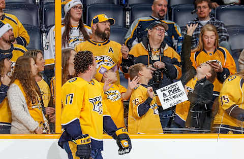 NASHVILLE, TN – DECEMBER 19: Scott Hartnell #17 of the Nashville Predators tosses a puck for luck to a young fan during warmups prior to an NHL game at Bridgestone Arena on December 19, 2017 in Nashville, Tennessee. (Photo by John Russell/NHLI via Getty Images)