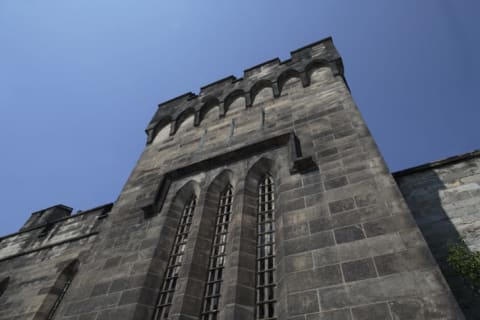 The building's battlements and exterior windows look imposing, but they're fake.