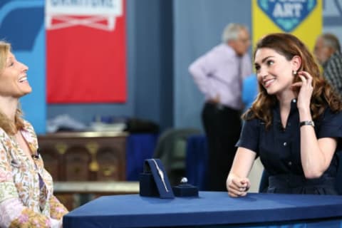 Antiques Roadshow appraiser Katherine Van Dell (R) looks at a watch and Art Deco star sapphire ring.