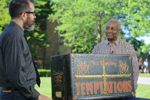 Antiques Roadshow appraiser Gary Piattoni examines a storage trunk that once belonged to the Temptations.