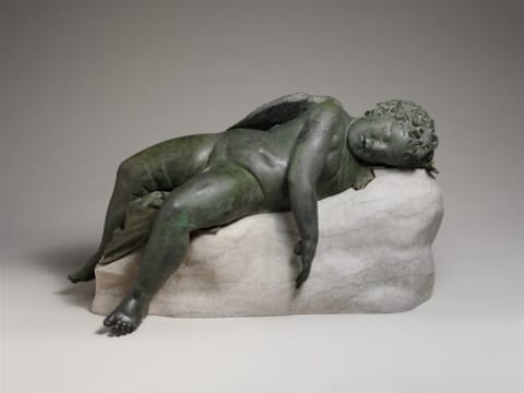 An ancient Greek bronze statue of Eros sleeping, of the type that might have inspired Michelangelo