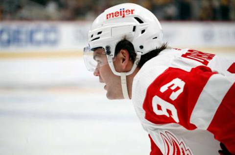 Oct 4, 2023; Pittsburgh, Pennsylvania, USA; Detroit Red Wings right wing Alex DeBrincat (93) looks on at the face-off circle against the Pittsburgh Penguins during the third period at PPG Paints Arena. Detroit won 2-1. Mandatory Credit: Charles LeClaire-USA TODAY Sports