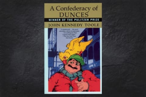 An image of the cover of A Confederacy of Dunces on a black background.