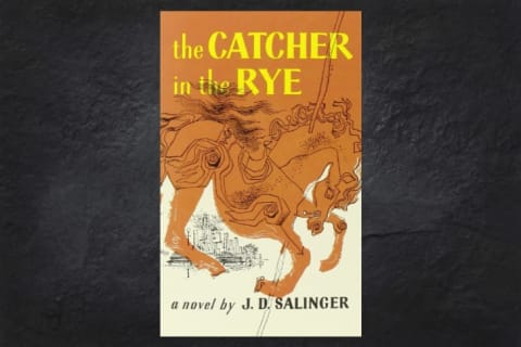 The cover of the book 'The Catcher in the Rye' on a black background.