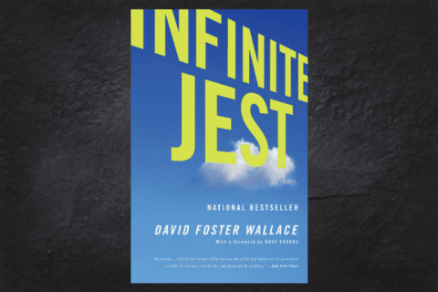 The cover of the book Infinite Jest on a black background.