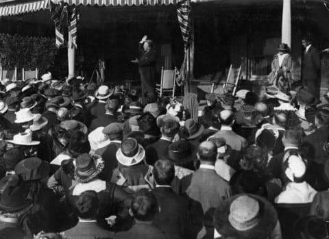 Theodore Roosevelt addresses a crowd of 500 suffragettes from the porch of his Sagamore Hill home around 1905.