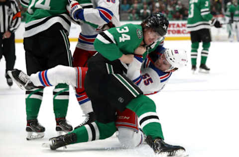 DALLAS, TEXAS – MARCH 10: Denis Gurianov #34 of the Dallas Stars and Ryan Lindgren #55 of the New York Rangers receive a roughing penalty during the first period at American Airlines Center on March 10, 2020 in Dallas, Texas. (Photo by Ronald Martinez/Getty Images)