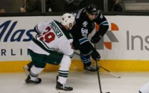 Jan 5, 2017; San Jose, CA, USA; San Jose Sharks center Melker Karlsson (68) and Minnesota Wild defenseman Nate Prosser (39) fight for control of the puck during the second period of the game at SAP Center at San Jose. The Minnesota Wild defeated the San Jose Sharks with a score of 5-4. Mandatory Credit: Stan Szeto-USA TODAY Sports