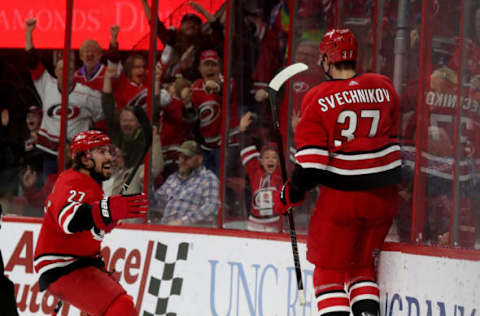 RALEIGH, NC – MARCH 24: Andrei Svechnikov #37 of the Carolina Hurricanes scores the game winning goal in overtime and celebrates with teammate Justin Faulk #27 during an NHL game against the Montreal Canadiens March 24, 2019 at PNC Arena in aleigh, North Carolina. (Photo by Gregg Forwerck/NHLI via Getty Images)