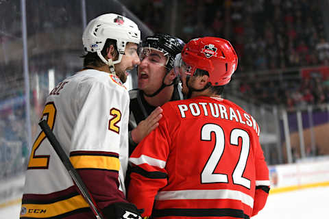 CHARLOTTE, NC – JUNE 01: The referee separates Charlotte Checkers Andrew Poturalski (22) and Chicago Wolves Nic Hague (2) during game one of the Calder Cup finals between the Chicago Wolves and the Charlotte Checkers on June 01, 2019 at Bojangles Coliseum in Charlotte,NC.(Photo by Dannie Walls/Icon Sportswire via Getty Images)