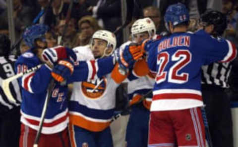 Oct 13, 2016; New York, NY, USA; New York Rangers defenseman Marc Staal (18) and New York Islanders center Shane Prince (11) and New York Islanders center Ryan Strome (18) and New York Rangers defenseman Nick Holden (22) fight during the first period at Madison Square Garden. Mandatory Credit: Brad Penner-USA TODAY Sports