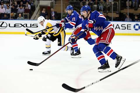 Apr 7, 2022; New York, New York, USA; New York Rangers defenseman Jacob Trouba (8) brings the puck up ice against the Pittsburgh Penguins during the second period at Madison Square Garden. Mandatory Credit: Brad Penner-USA TODAY Sports