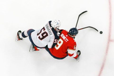 SUNRISE, FL – DECEMBER 13: Yegor Chinakhov #59 of the Columbus Blue Jackets defends against Sam Bennett #9 of the Florida Panthers as he skates towards the goal with the puck at the FLA Live Arena on December 13, 2022 in Sunrise, Florida. (Photo by Joel Auerbach/Getty Images)