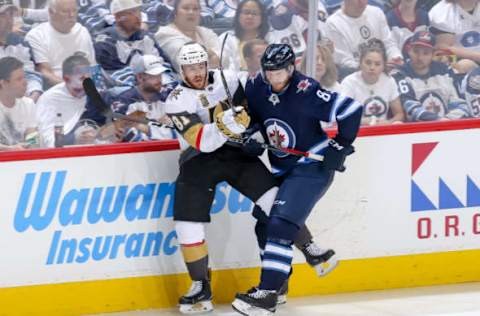 WINNIPEG, MB – MAY 20: Jonathan Marchessault #81 of the Vegas Golden Knights battles Jacob Trouba #8 of the Winnipeg Jets along the boards during third period action in Game Five of the Western Conference Final during the 2018 NHL Stanley Cup Playoffs at the Bell MTS Place on May 20, 2018 in Winnipeg, Manitoba, Canada. (Photo by Jonathan Kozub/NHLI via Getty Images)