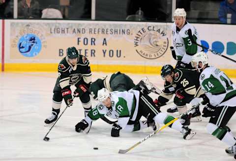 CEDAR PARK, TX – OCTOBER 19: Texas Stars center James Phelan (18) battles for a loose puck with Iowa Wild players Sam Anas (7) and Justin Kloos during 5 – 4 win over the Iowa Wild on October 19, 2018, at the HEB Center in Cedar Park, TX. (Photo by John Rivera/Icon Sportswire via Getty Images)