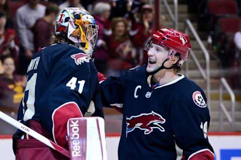 Feb. 18, 2013; Glendale, AZ, USA; Phoenix Coyotes goalie Mike Smith (41) celebrates with right wing Shane Doan (19) after beating the Calgary Flames 4-0 at Jobing.com Arena. Mandatory Credit: Matt Kartozian-USA TODAY Sports