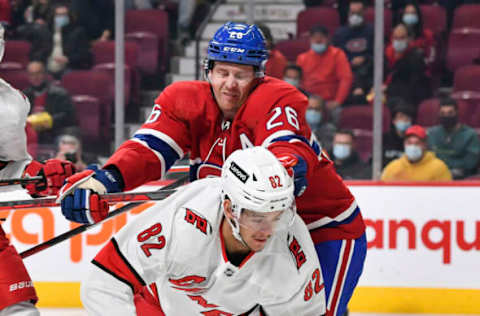 MONTREAL, QC – OCTOBER 21: Jeff Petry #26 of the Montreal Canadiens delivers a check on Jesperi Kotkaniemi #82 of the Carolina Hurricanes during the first period at Centre Bell on October 21, 2021, in Montreal, Canada. (Photo by Minas Panagiotakis/Getty Images)