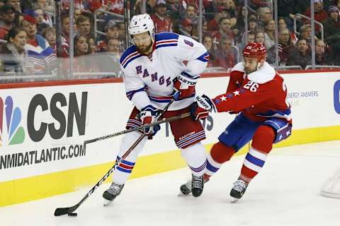 Mar 4, 2016; Washington, DC, USA; New York Rangers defenseman Kevin Klein (8) skates with the puck as Washington Capitals right wing Daniel Winnik (26) defends in the third period at Verizon Center. The Rangers won 3-2. Mandatory Credit: Geoff Burke-USA TODAY Sports